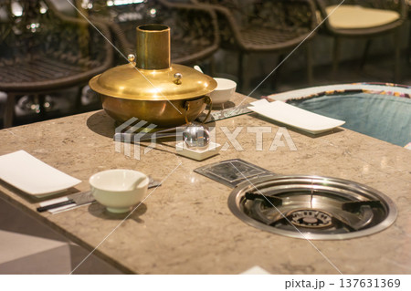 Hot pot table setting with brass pot and built-in burner Hot pot table setting with brass pot and built-in burner 137631369