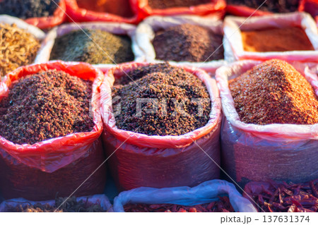 Colorful ground spices in sacks at outdoor market 137631374