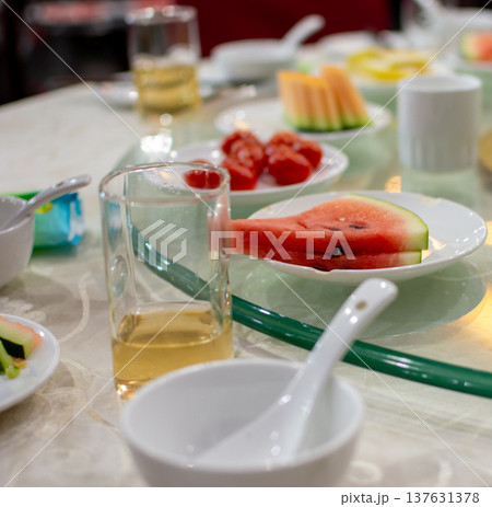 Dining table with fresh fruit plates and tea glasses 137631378