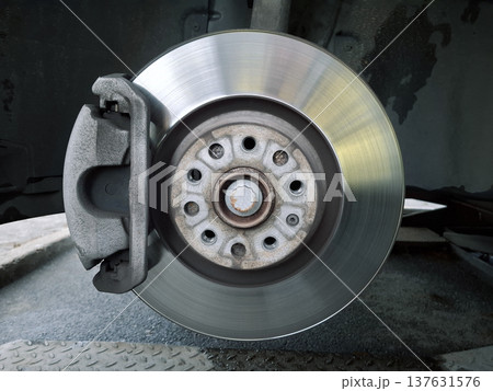Brake disc and brake pads. Wheel disassembly and repair. Car at service station 137631576