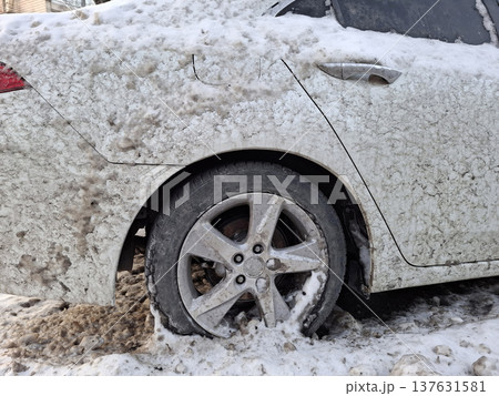 White car is splashed with mud from the road. The whole car is dirty 137631581