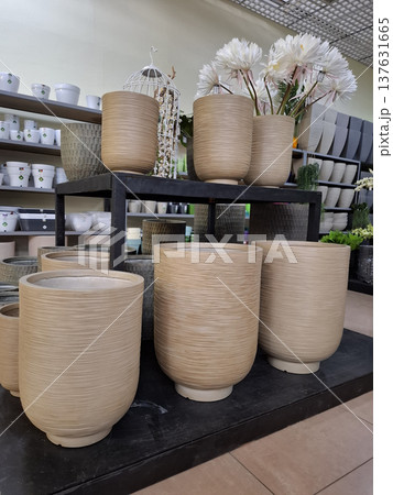 Ceramic flower pots on supermarket shelves. Ceramic products in flower shop 137631665