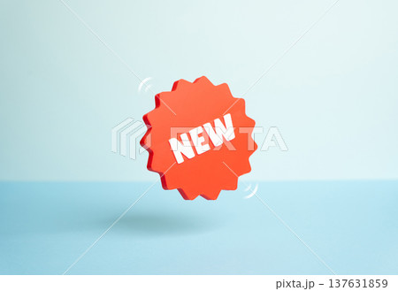 A New sticker levitating on a blue background. Symbol of new products and services entering the market. Marketing promotion highlights innovation, product launches and fresh commercial opportunities. A New sticker levitating on a blue background. Symbol of new products and services entering the market. Marketing promotion highlights innovation, product launches and fresh commercial opportunities. 137631859