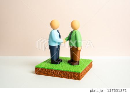 An agreement to purchase or sell a plot of land. Two parties enter into a transaction and sign legal documents. Real estate deal, property transfer and formal contract between buyer and seller. An agreement to purchase or sell a plot of land. Two parties enter into a transaction and sign legal documents. Real estate deal, property transfer and formal contract between buyer and seller. 137631871