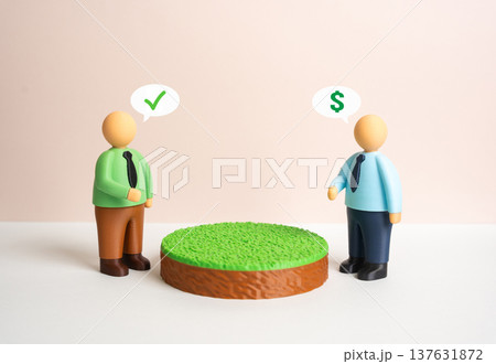 A buyer and seller negotiate a deal for a plot of land. Discussion of price, terms and conditions of purchase. Real estate bargaining, land valuation and agreement before signing a contract. 137631872