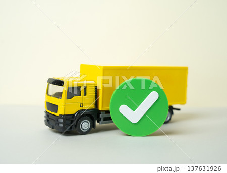 A transport truck and a green checkmark. Passed inspection and certification approved for transportation. Logistics compliance and safety control confirming legal access to cargo delivery routes. A transport truck and a green checkmark. Passed inspection and certification approved for transportation. Logistics compliance and safety control confirming legal access to cargo delivery routes. 137631926