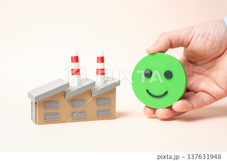 An industrial plant and the symbol of a smiling face. Industrial sector growth and positive economic outlook. Investments and government orders support factories, manufacturing expansion 137631948