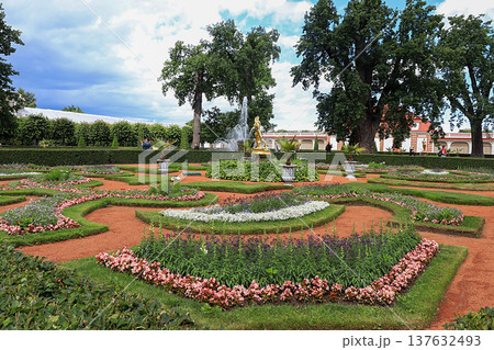 Russia, St. Petersburg, Peterhof, July 9, 2020. In the photo: the Monplaisir complex in the Lower Park of the Peterhof State Museum-Reserve and people walking in the park. 137632493