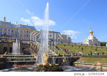 Russia, St. Petersburg, Peterhof, July 12, 2021. The photo shows the fountain of the Grand Cascade in the Lower Park of the State Museum-Reserve "Peterhof" and people walking in the park, selective Russia, St. Petersburg, Peterhof, July 12, 2021. The photo shows the fountain of the Grand Cascade in the Lower Park of the State Museum-Reserve "Peterhof" and people walking in the park, selective 137633104