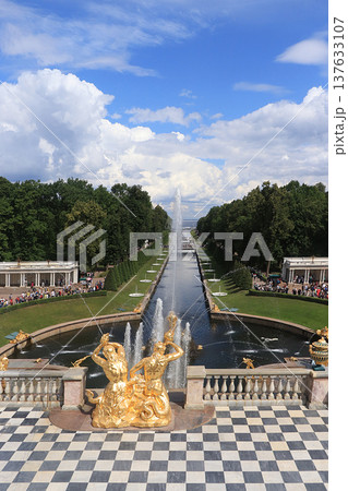 Russia, St. Petersburg, Peterhof, July 8, 2019. In the photo: the fountain of the Grand Cascade in the Lower Park of the State Museum Reserve "Peterhof" and people who walk in the park and admire Russia, St. Petersburg, Peterhof, July 8, 2019. In the photo: the fountain of the Grand Cascade in the Lower Park of the State Museum Reserve "Peterhof" and people who walk in the park and admire 137633107