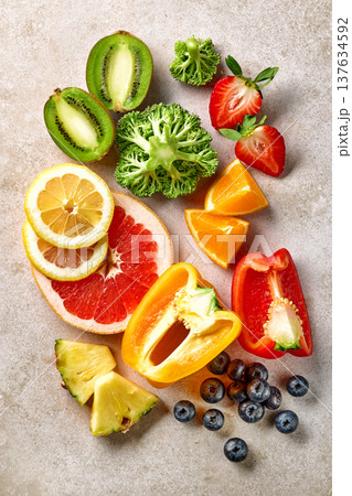 Vitamin C rich fruits and vegetables arranged on light background, top view 137634592