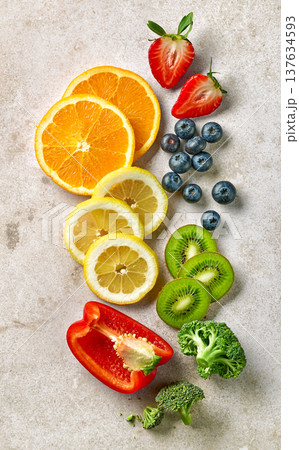 Vitamin C rich fruits and vegetables arranged on light background, top view 137634593