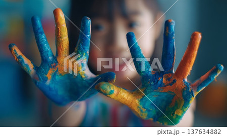 Joyful little girl with colorful paint covered hands, celebrating creativity and artistic expression in a vibrant atmosphere. Joyful little girl with colorful paint covered hands, celebrating creativity and artistic expression in a vibrant atmosphere. 137634882