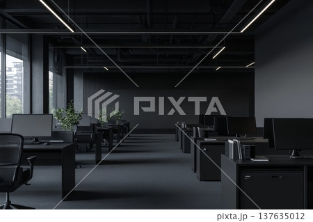 A Dimly Lit Office Space Filled with Rows of Desks, Computers, and Office Supplies for Busy Professionals 137635012