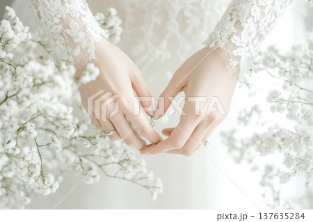 Romantic Bride in Elegant Wedding Dress Holding a Shimmering Engagement Ring Under Soft Natural Lighting Romantic Bride in Elegant Wedding Dress Holding a Shimmering Engagement Ring Under Soft Natural Lighting 137635284