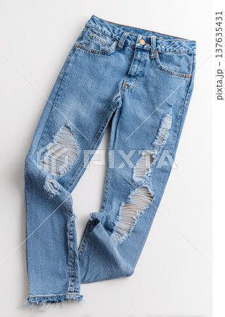 Full-length blue ripped jeans on a white background Full-length blue ripped jeans on a white background 137635431