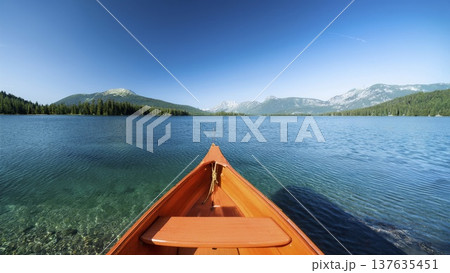 An orange boat in a beautiful clear lake in the middle of a mountain landscape on a sunny day An orange boat in a beautiful clear lake in the middle of a mountain landscape on a sunny day 137635451