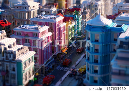 A city with houses, streets, and cars stylized like Lego bricks 137635480