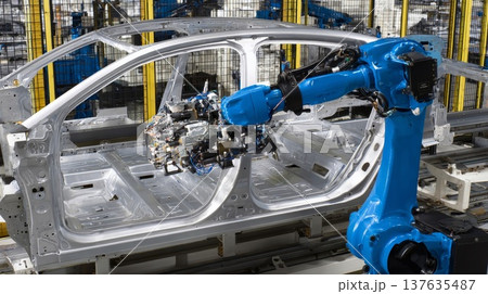 An industrial robot welds a car frame on a modern automated assembly line in an automotive factory. 137635487