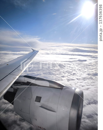View from an airplane window of clouds and an engine View from an airplane window of clouds and an engine 137636398