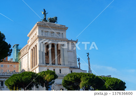 Historic building at a sunny day in Rome near green trees and blue sky Historic building at a sunny day in Rome near green trees and blue sky 137636600