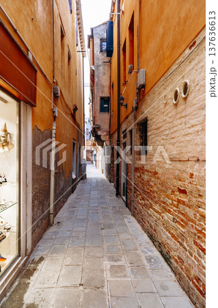 Narrow walkway between buildings in a historic area with shops and stone pathways Narrow walkway between buildings in a historic area with shops and stone pathways 137636613