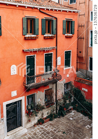 Colorful building with window boxes in a quiet courtyard in Venice during the afternoon Colorful building with window boxes in a quiet courtyard in Venice during the afternoon 137636729
