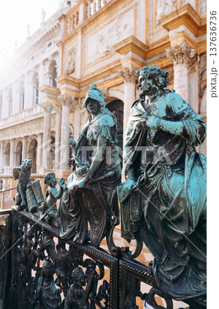 Statues at a historic location in Venice engage visitors during daylight hours 137636736
