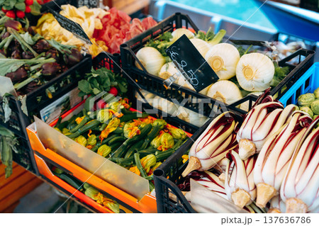 Fresh vegetables and herbs at the market stand during daytime shopping hours 137636786