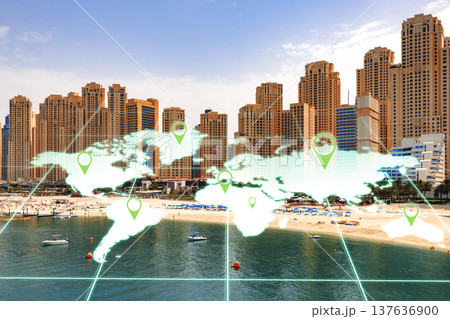 View of a beach area with city buildings and a world map overlay showing location markers 137636900