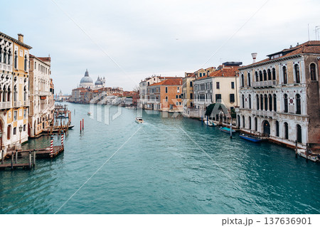 View of Grand Canal in Venice with boats and historic buildings on a cloudy day View of Grand Canal in Venice with boats and historic buildings on a cloudy day 137636901
