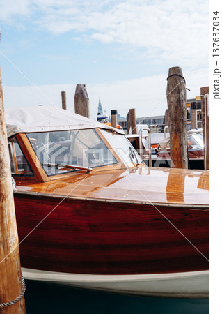 Boats docked at a busy marina on a sunny day with clear skies 137637034
