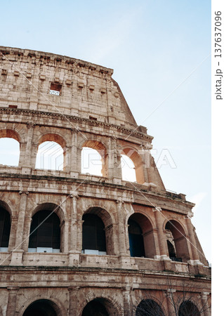 Colosseum in Rome shows ancient architecture under clear sky during daylight hours 137637096