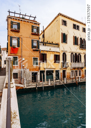 Buildings along a canal in a quiet part of Venice during a cloudy day in autumn 137637097