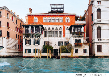 Historic building by the water in Venice with colorful windows and balconies during daytime 137637106
