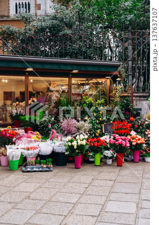 Flower shop displays colorful bouquets in city center during midday Flower shop displays colorful bouquets in city center during midday 137637107