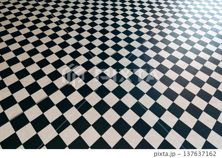Checkerboard floor design with black and white squares in a modern setting 137637162