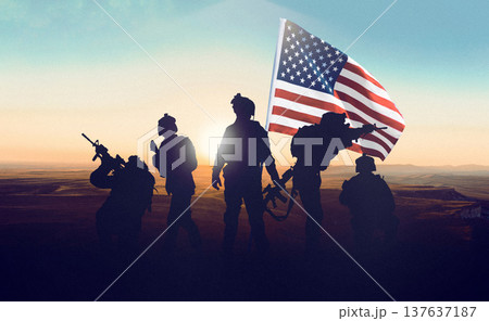 US soldiers stand together with an American flag during a conflict in Iran at sunset 137637187