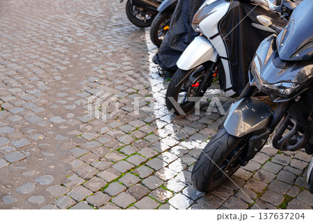 Bikes parked on cobblestone road near buildings in city 137637204