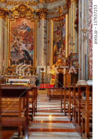 Visitors view art and architecture inside a historic church during daylight hours Visitors view art and architecture inside a historic church during daylight hours 137637253