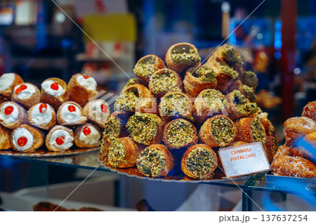 Sweet display of cannoli and pastries in a bakery during the afternoon in Italy 137637254