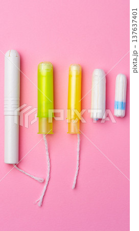 Different types of tampons shown in a row with bright backgrounds Different types of tampons shown in a row with bright backgrounds 137637401