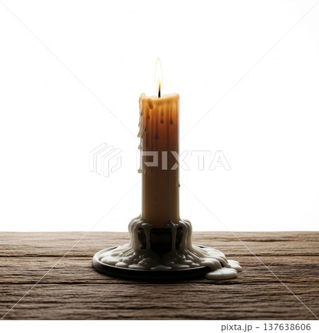 Lit Candle with Dripping Wax on Wooden Table Against White Background 137638606
