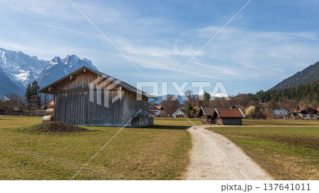 Scenic rural panorama with barn and Alpine mountains in Bavaria Germany Scenic rural panorama with barn and Alpine mountains in Bavaria Germany 137641011