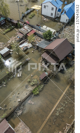 Spring flood disaster with fully submerged houses, flooded roads and overflowing waterways. The footage shows the dramatic impact of heavy rainfall and rising water levels on residential areas Spring flood disaster with fully submerged houses, flooded roads and overflowing waterways. The footage shows the dramatic impact of heavy rainfall and rising water levels on residential areas 137643632