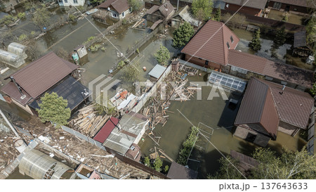 Spring flood disaster with fully submerged houses, flooded roads and overflowing waterways. The footage shows the dramatic impact of heavy rainfall and rising water levels on residential areas Spring flood disaster with fully submerged houses, flooded roads and overflowing waterways. The footage shows the dramatic impact of heavy rainfall and rising water levels on residential areas 137643633