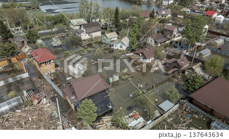 Spring flood disaster with fully submerged houses, flooded roads and overflowing waterways. The footage shows the dramatic impact of heavy rainfall and rising water levels on residential areas Spring flood disaster with fully submerged houses, flooded roads and overflowing waterways. The footage shows the dramatic impact of heavy rainfall and rising water levels on residential areas 137643634