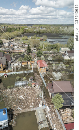 Spring flood disaster with fully submerged houses, flooded roads and overflowing waterways. The footage shows the dramatic impact of heavy rainfall and rising water levels on residential areas Spring flood disaster with fully submerged houses, flooded roads and overflowing waterways. The footage shows the dramatic impact of heavy rainfall and rising water levels on residential areas 137643636