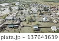 Spring flood disaster with fully submerged houses, flooded roads and overflowing waterways. The footage shows the dramatic impact of heavy rainfall and rising water levels on residential areas 137643639
