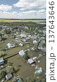 Spring flood disaster with fully submerged houses, flooded roads and overflowing waterways. The footage shows the dramatic impact of heavy rainfall and rising water levels on residential areas 137643646